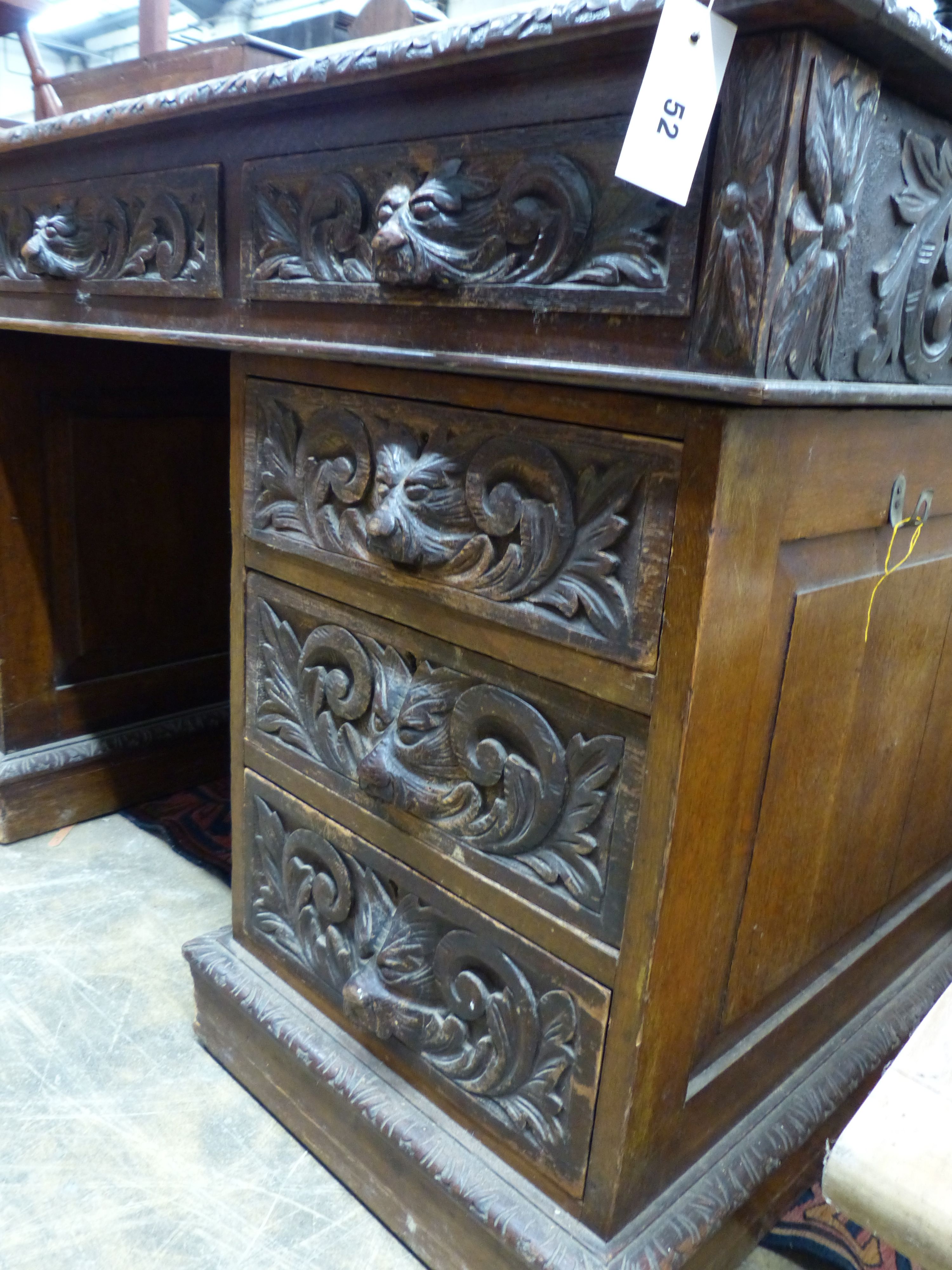 A late Victorian carved oak pedestal desk, length 138cm